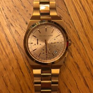 Like new, never worn Michael Kors chronograph watch in rose gold.